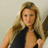 In very short secretary dress with tan pantyhose and boots